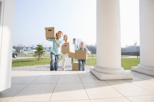 Staff using PPE while loading items into a van