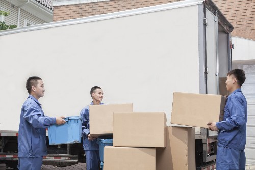 Removal team loading boxes and furniture for a home move in Poplar
