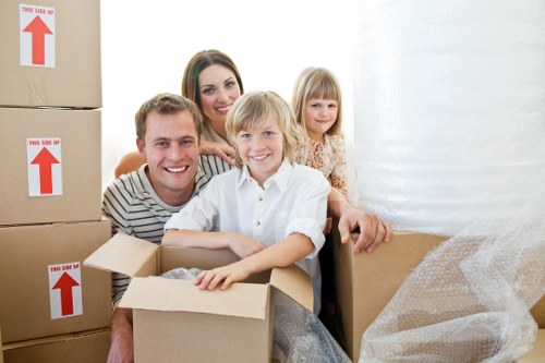 Movers carrying furniture through a narrow staircase in Poplar